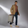Silver hard-shell trolley suitcase with laptop compartment and four spinner wheels