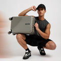 Charcoal grey small cabin suitcase with ribbed shell, top handle and four corner wheels