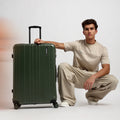 Large check-in suitcase in dark green with telescopic handle and spinner wheels