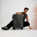 HRX medium check-in suitcase in dark charcoal grey with 8 wheels and ribbed shell