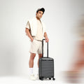 Charcoal hard-shell check-in suitcase with telescopic handle and 8 spinner wheels
