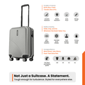 Silver cabin suitcase with textured shell, 8-wheel spinner base, and black handle