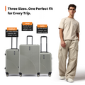 Light gray hard-shell check-in suitcase with retractable handle and spinner wheels