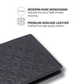 Dark green leather bifold wallet with embossed R monogram pattern, close corner view