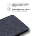 Dark blue leather bifold wallet with embossed R monogram pattern, front close-up