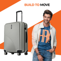 Light gray hard-shell check-in suitcase with retractable handle, four spinner wheels
