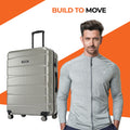 Silver hard-shell suitcase with upright handle and rolling wheels