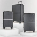 Hard-shell luggage set with three upright cases on spinner wheels and telescopic handles