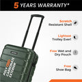 Green small cabin suitcase close-up with telescopic handle and textured shell panels