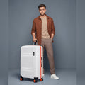 Large check-in suitcase with hard shell, orange-trim accents, and 8 wheels, white/grey.