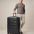 Large check-in suitcase, black hard shell with 8 wheels and telescopic handle
