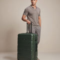 Medium check-in polycarbonate suitcase, dark green, 8-wheel, telescopic handle