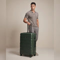 Dark green polycarbonate medium check-in suitcase with 8 wheels and telescopic handle