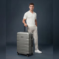 Silver polycarbonate medium check-in suitcase with 8 wheels and front carry handle