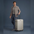 Silver small cabin suitcase with ridged hard shell and 8 spinner wheels