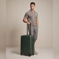 Small cabin suitcase, dark green polycarbonate, front view with 8 wheels