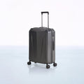 Dark hard-shell trolley luggage with textured sides, telescopic handle, and spinner wheels
