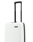 White cabin suitcase with top handle extended and black base trim, rear view