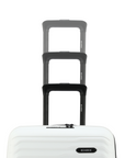 Stacked white cabin suitcases with black handles, top view of three sizes
