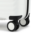 White cabin suitcase with black wheel housing and smooth rolling wheel close-up