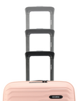 Stack of peach small cabin suitcases with black handles and ridged front panels.