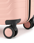 Peach small cabin suitcase with black handle and multi-direction wheels detail