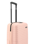 Pink cabin suitcase with ribbed hard shell and black telescopic handle frame