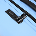 Light blue suitcase with black zip pull and integrated combination lock panel