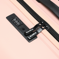 Peach hard-shell luggage with black zipper track and combination lock panel