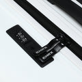 Medium check-in suitcase combination lock on black strap, close-up of zipper teeth.