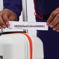 White cabin suitcase label at zipper edge with red trim