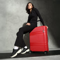 Red large hard-shell check-in suitcase with telescopic handle and 8 wheels, black base