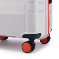 HRX Helium suitcase wheel close-up with red hub and black housing on white shell
