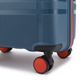 Grey-blue medium suitcase with orange trim and four dual wheels on the corner.