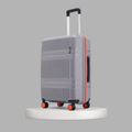 Grey suitcase side view with telescopic handle, orange edge trim, and four wheels.