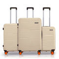 Three-piece beige luggage set with pull handles and spinner wheels
