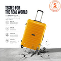 Yellow poly trolley suitcase with telescopic handle, four wheels, and impact marks