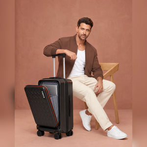 Black hard-shell trolley suitcase with front laptop pocket, spinner wheels and handle