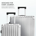 Two silver polycarbonate suitcases standing upright with telescopic handles