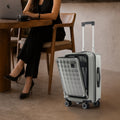 Grey polycarbonate cabin trolley with quilted front, telescopic handle, and 8 wheels
