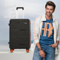 Black ribbed rolling suitcase with telescopic handle and orange-accented wheels