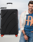 Black hard-shell suitcase with 8 wheels and telescopic handle.
