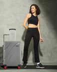 Grey hard-shell suitcase with 8 wheels and telescopic handle.