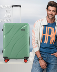 Hard-shell luggage set in green with telescopic handle and four red wheels each