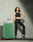 Green hard-shell suitcase with 8 wheels and telescopic handle.