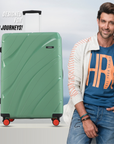Green hard-shell luggage with black top handle and red corner wheels, front view