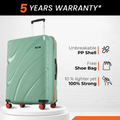 Green hard-shell check-in suitcase with 8 wheels, red trim, and upright handle.