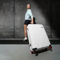 White hard-shell suitcase with 8 wheels and telescopic handle.