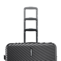 Stacked charcoal hard-shell suitcases with telescopic handles and ridged shell.