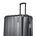 Large check-in suitcase in dark grey with top handle and vertical ridged shell